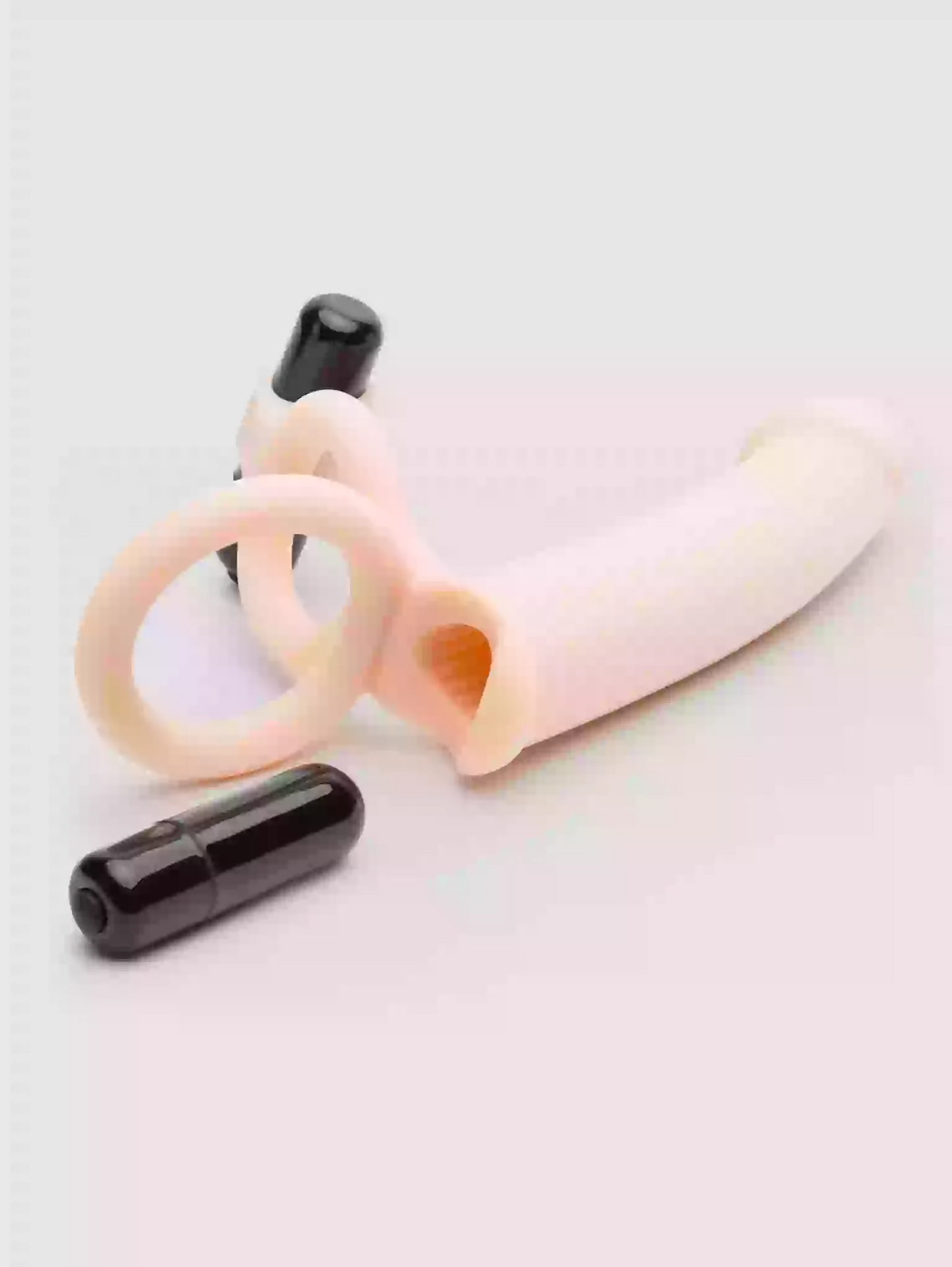Two black cylindrical objects on a light pink background