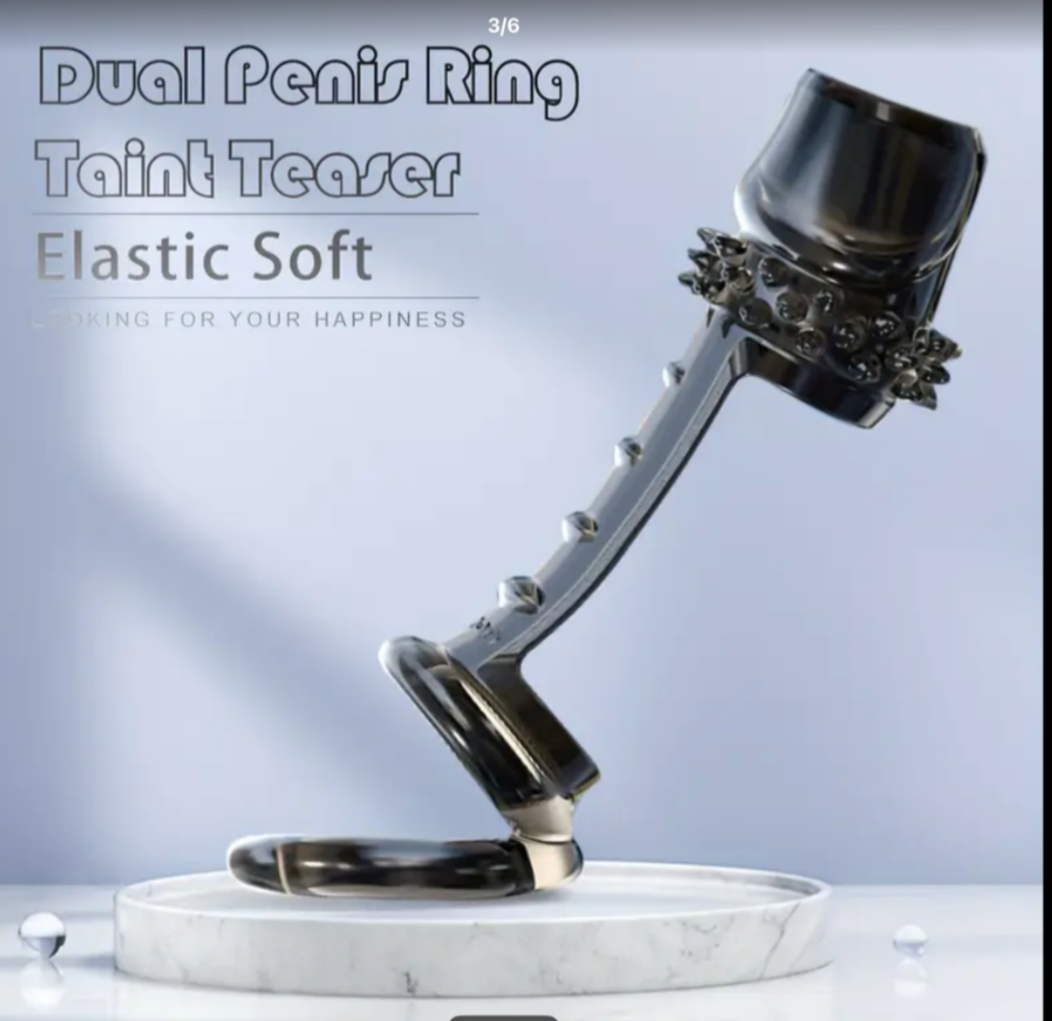 Dual penis ring with decorative elements on a marble base against a light gray background.