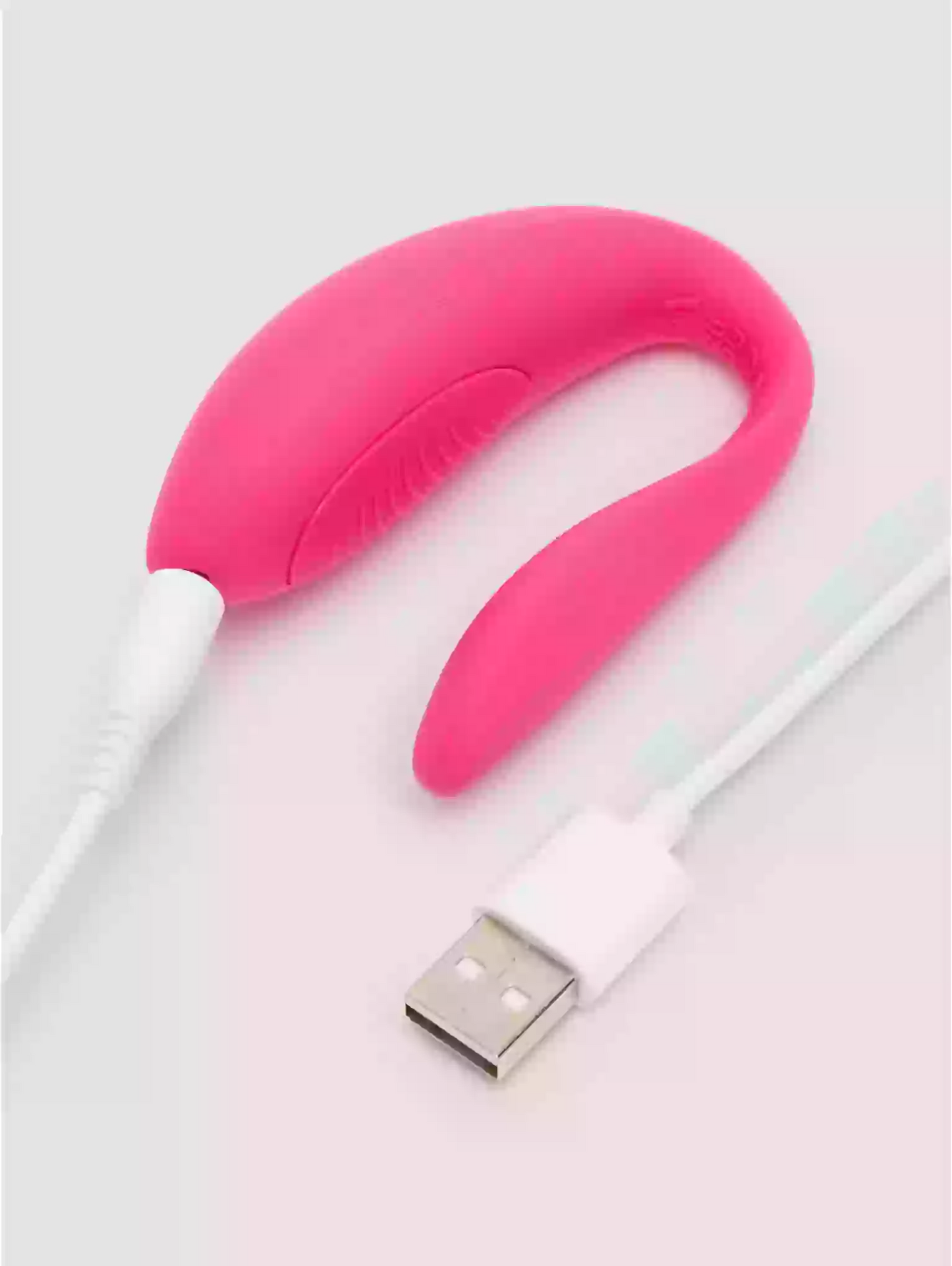 Pink USB charging cable on a white background