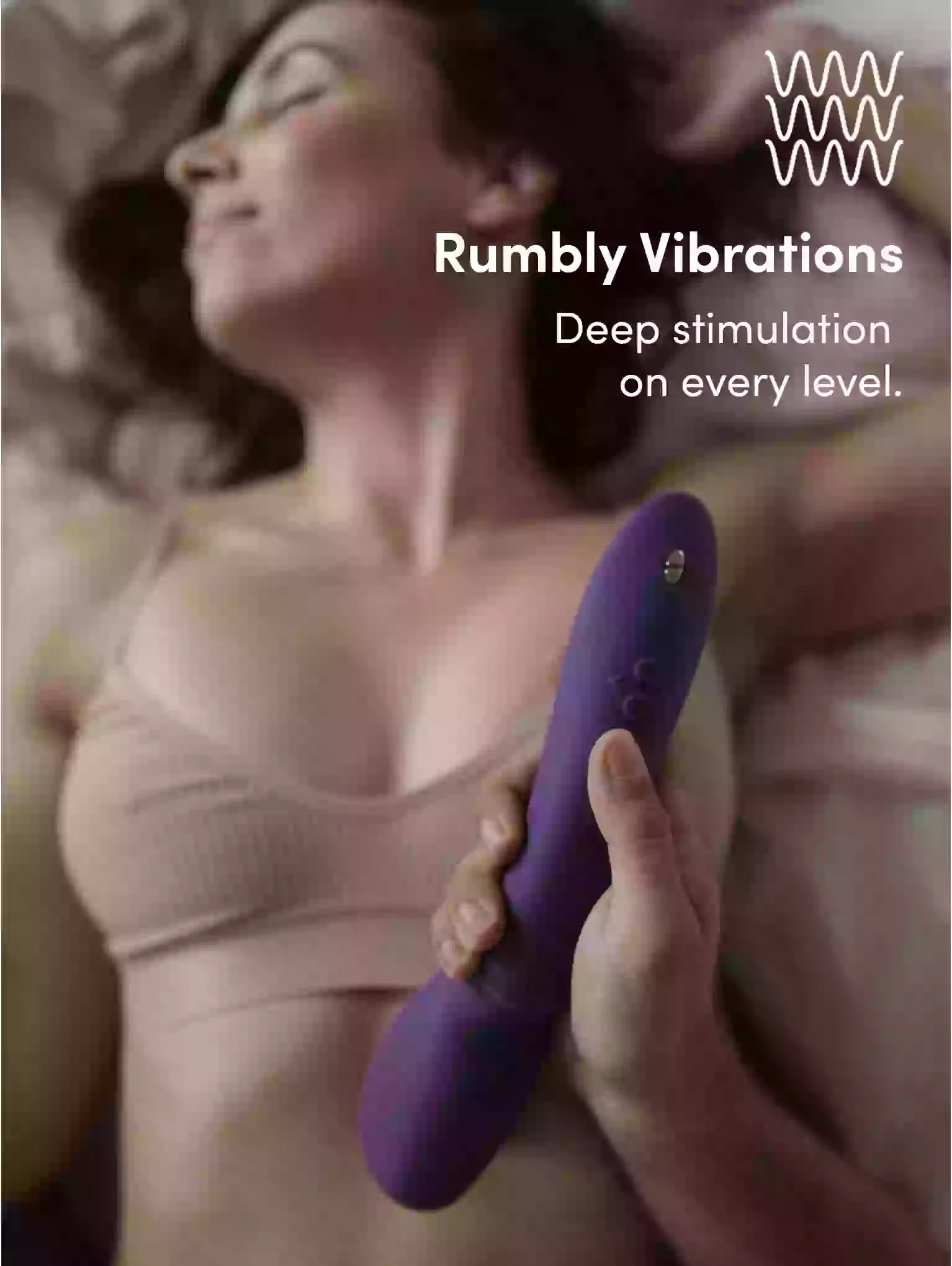 Person holding a purple electronic device with 'Rumbly Vibrations' text and logo.