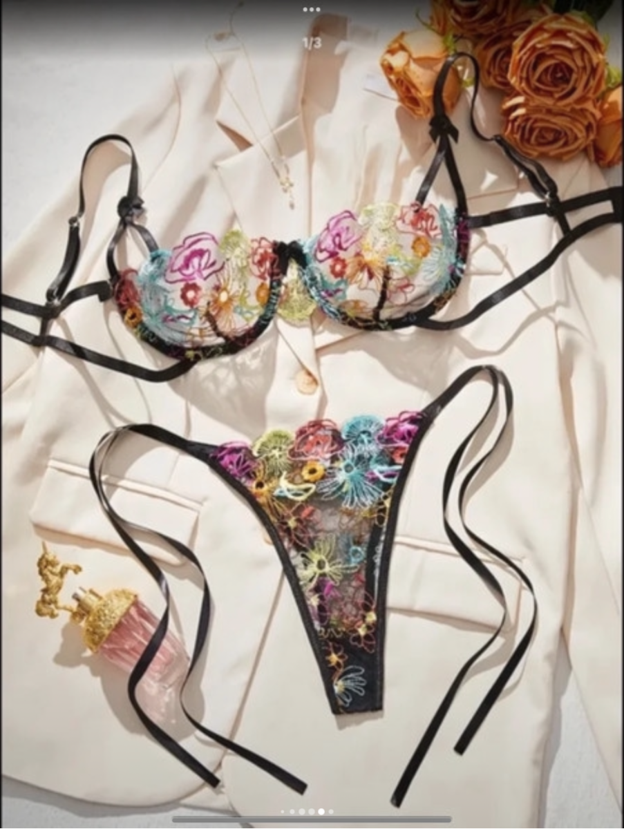 Floral embroidered lingerie set on a light background with flowers.