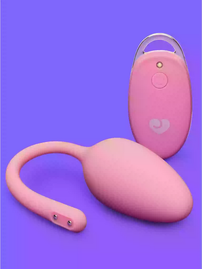 Pink electronic device with a remote control on a purple background